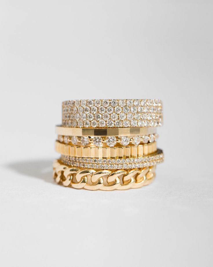 a stack of gold and diamond bracelets