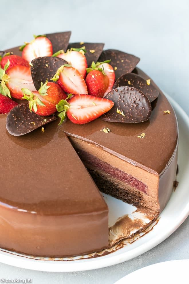 a chocolate cake with sliced strawberries on top