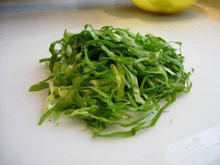 a pile of alfalfa sitting on top of a white cutting board