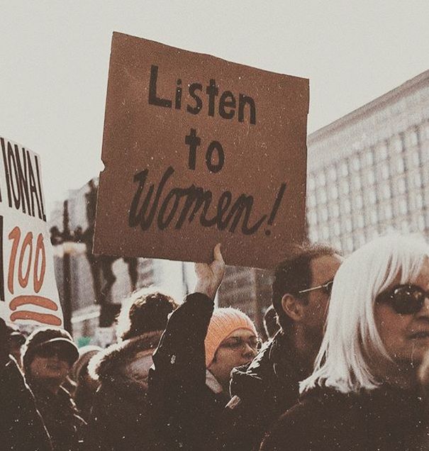 a group of people holding up signs in the air