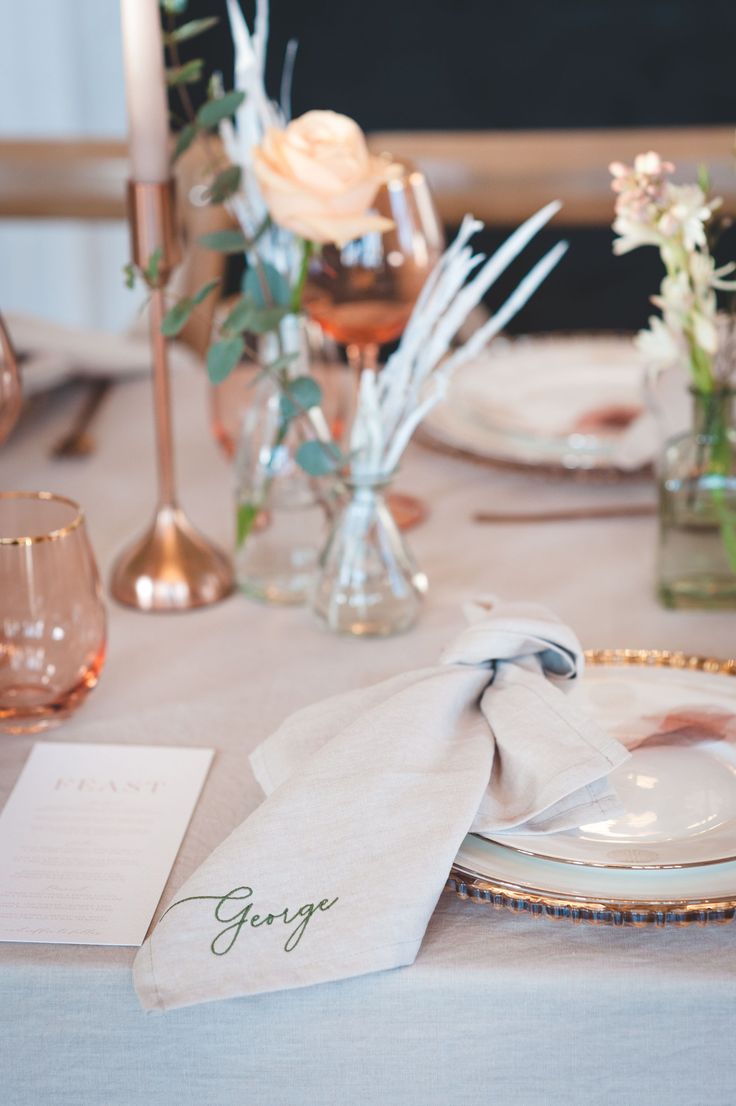 a table set with place settings and napkins