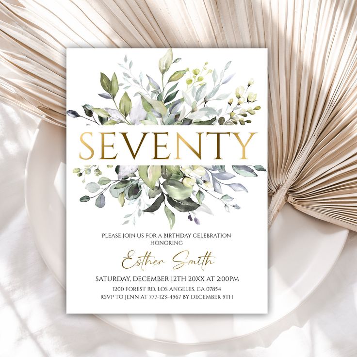 an elegant birthday party with greenery and gold foil lettering on a white card stock photo