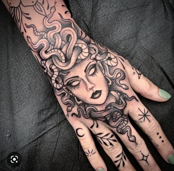 a woman's hand with tattoos on it