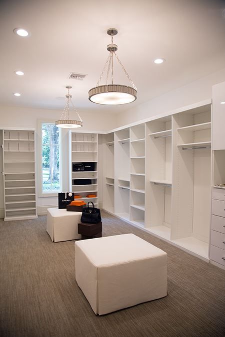 an empty white room with lots of shelves