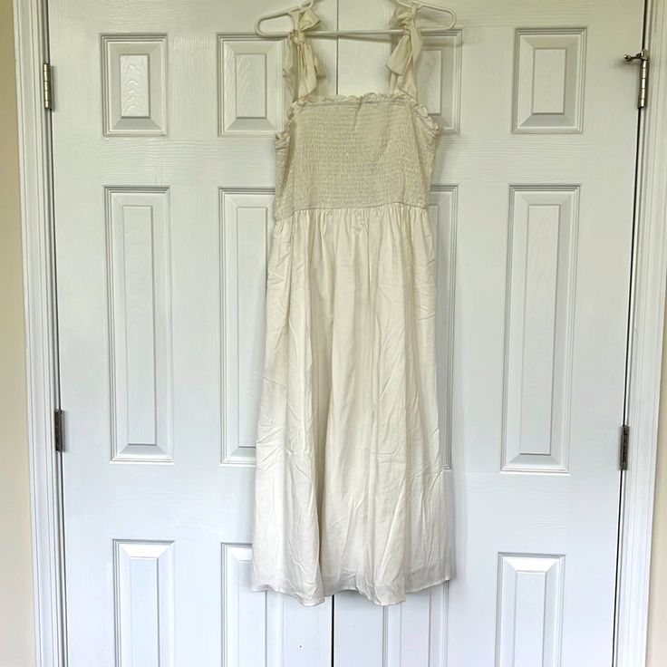 Perfect For Wedding Shower Or Rehearsal Dinner, Especially For Summer Brides! Never Worn. Straps Are Adjustable As They Tie In Bows. Stretchy Top. Mid Length White Sleeveless Dress With Smocked Bodice, Cream Sleeveless Maxi Dress For Summer, Sleeveless Cream Maxi Dress For Casual Wear, Cream Sleeveless Maxi Dress For Casual Occasions, Cream Sleeveless Summer Maxi Dress, Feminine Sleeveless Cream Maxi Dress, Sleeveless Cream Midi Dress For Casual Wear, Cream Sleeveless Midi Dress For Casual Occasions, Sleeveless Summer Maxi Dress For Wedding