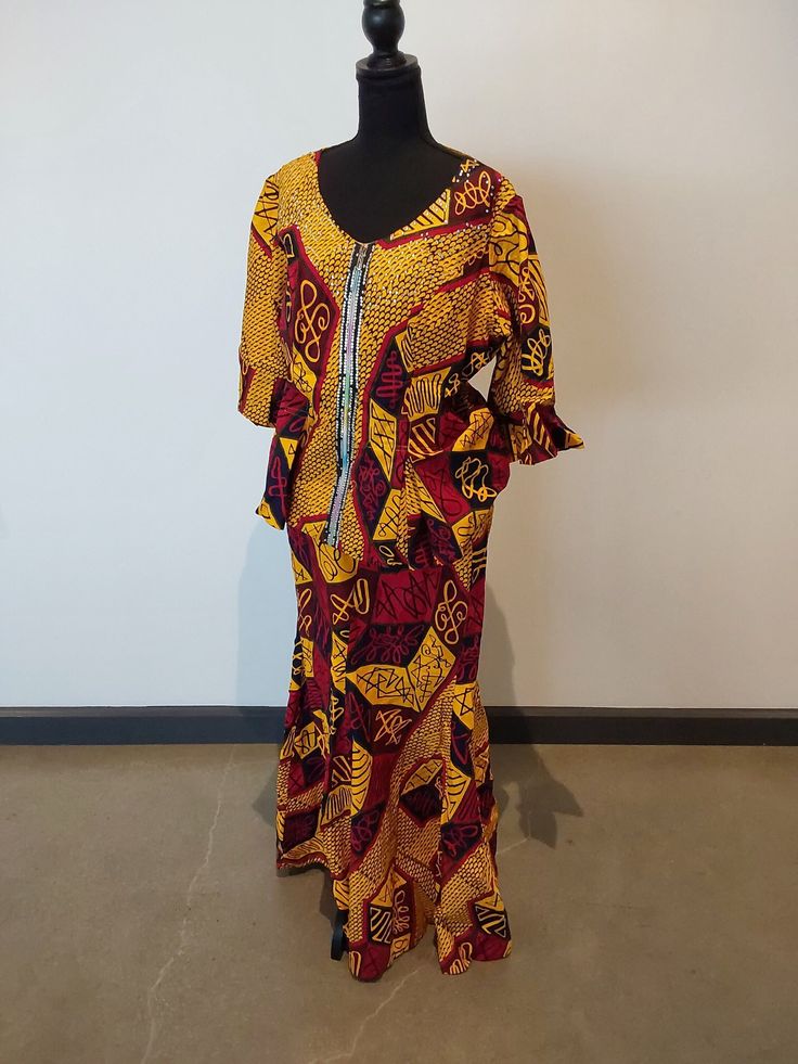 "Discover the allure of the \"Olaedo\" Igbo dress, an exquisite blend of tradition and contemporary sophistication, exclusively available at our Etsy store. This opulent garment celebrates the richness of Igbo heritage, meticulously crafted to embody grace and prosperity. Drenched in resplendent gold, the Olaedo dress symbolizes wealth and royalty, each thread intricately woven to capture the essence of Igbo culture. With a secondary color of vibrant red, this dress infuses passion and energy, paying homage to the Igbo people's resilience. Featuring traditional Igbo motifs and patterns, the dress is a wearable work of art, telling a story of cultural significance through symbolic embroidery. The silhouette, a perfect fusion of modern tailoring and traditional elements, ensures a flattering Igbo Clothing, Fitted Maxi Dress With Traditional Patterns, Elegant Festive Maxi Dress With Traditional Patterns, Fitted Yellow Dress With Traditional Patterns, Elegant Fitted Maxi Dress With Traditional Patterns, Elegant Long Sleeve Maxi Dress With Traditional Patterns, Elegant Maxi Dress With Traditional Patterns For Ceremonies, Elegant Maxi Dress With Traditional Patterns, Fitted Maxi Dress With Traditional Patterns For Ceremonies