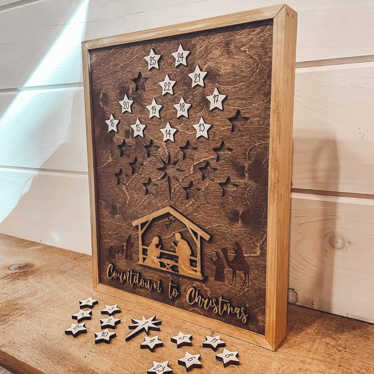 a nativity scene made out of wood with star cut outs and stars on the side