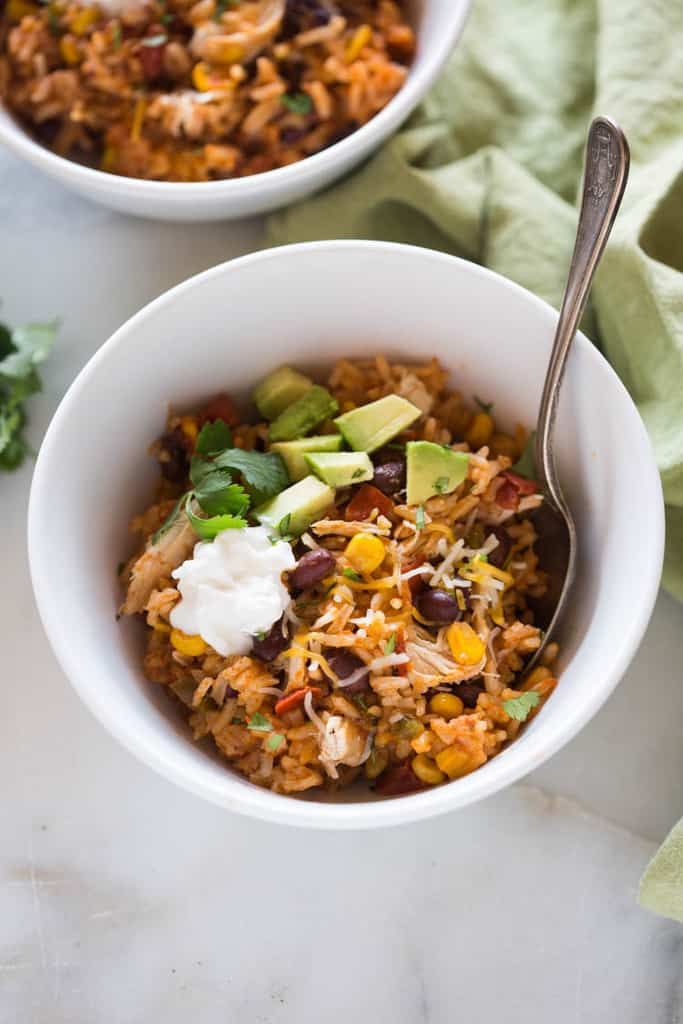 two bowls filled with mexican rice and beans