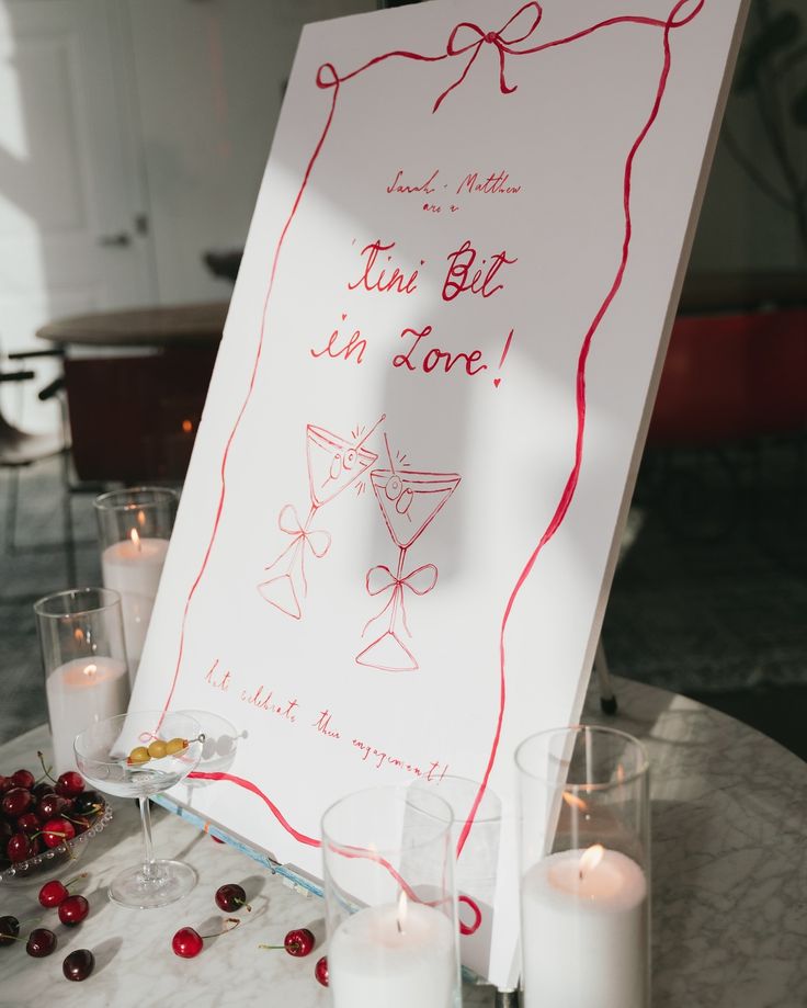 a sign that is on top of a table with some candles and other items around it