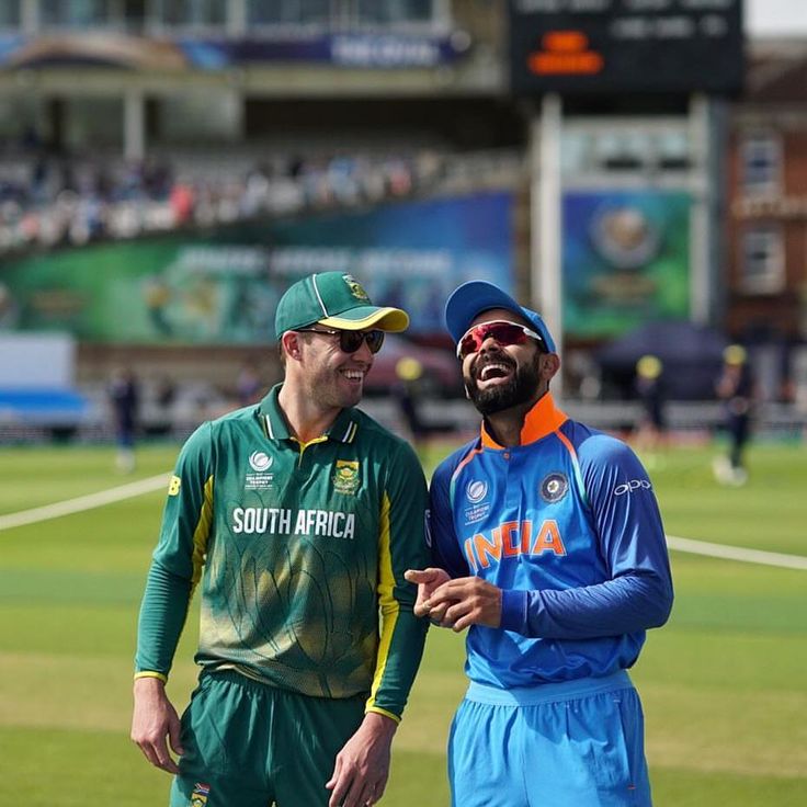 two men standing next to each other on a field