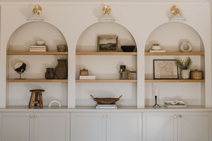 the shelves are lined with books, vases and other decorative items on top of them