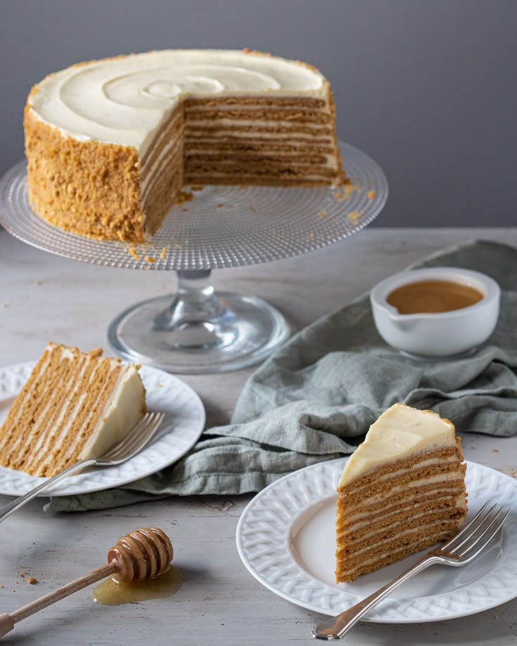 slices of cake sitting on plates next to a cup of coffee and a honey comb