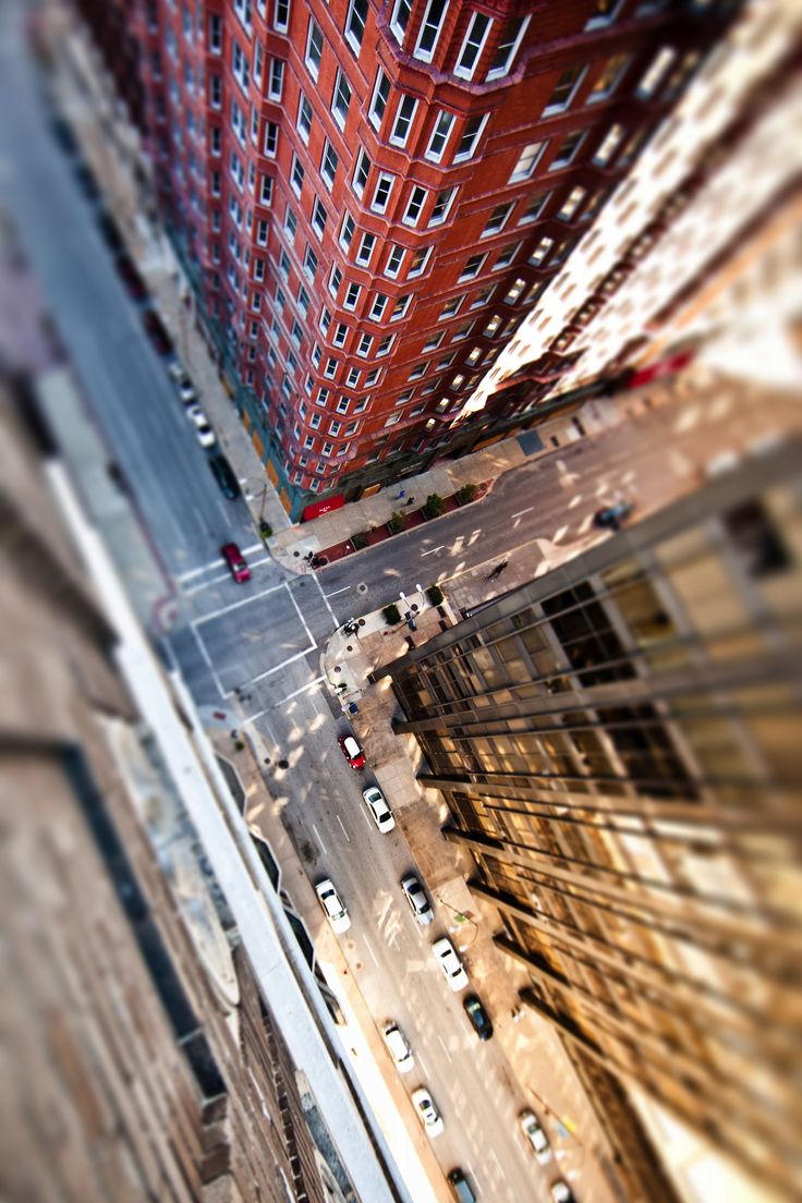 looking up at tall buildings in the city from high up on a street level view