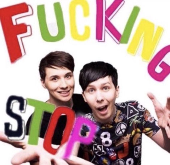 two young men are posing for the camera with their hands up in front of them