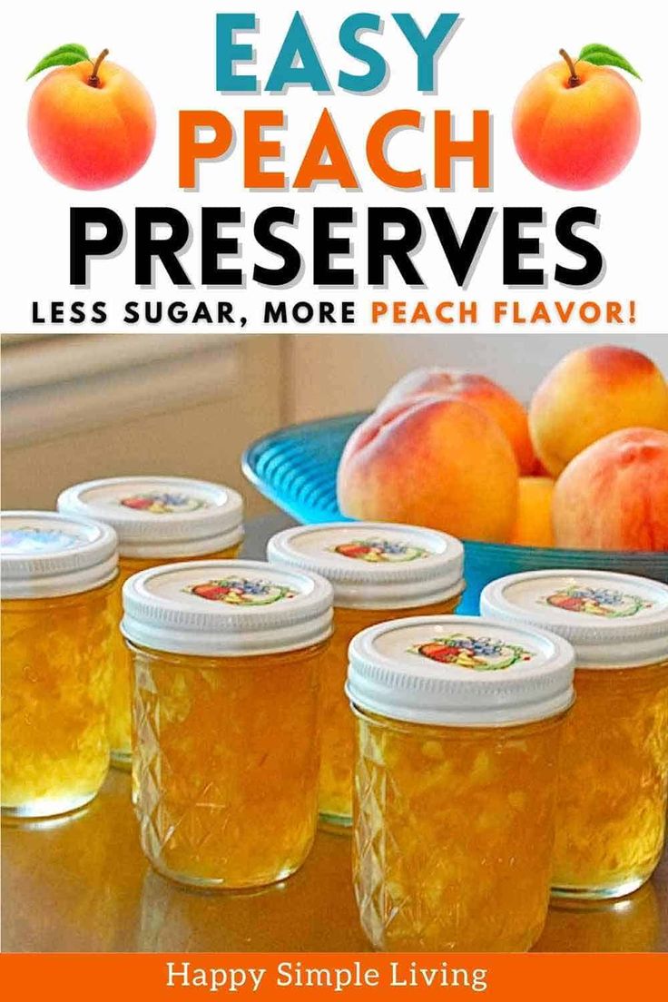 four jars filled with peach preserves sitting on top of a table