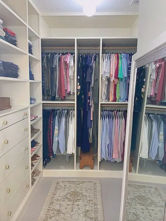 a walk in closet filled with lots of clothes