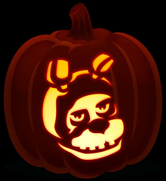 a pumpkin with an image of a dog on it's face in the dark