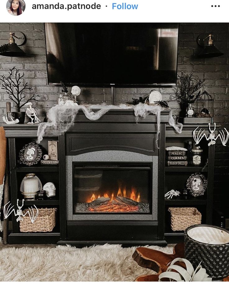 a living room decorated for halloween with white and black decorations on the fireplace mantles