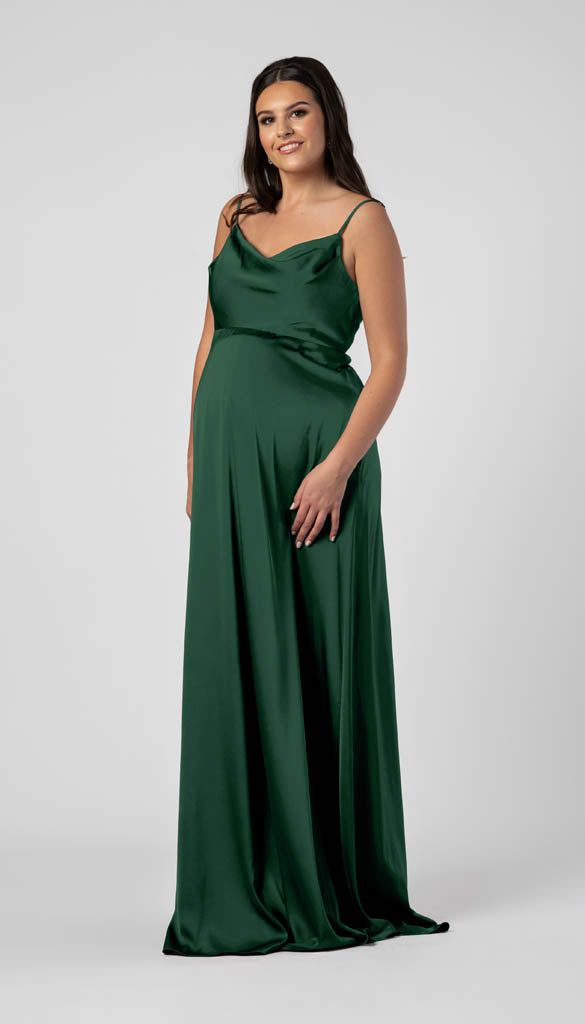 Dress Details Get ready to slay the bridesmaid game in Leo, our maternity dress that's as stylish as it is comfy. Made with satin fabric, this style is designed to flatter your bump. With pockets, a trendy square neckline, and an empire waistline, this modern and chic dress is the perfect choice for expecting mamas. Features of Leo: Maternity Satin A-line Pockets Cowl Neck V-back Sewn in bra cups Invisible YKK zipper Dress accommodates for a height of up to 5’11” Fit and Sizing When taking measu Green Maternity Bridesmaid Dress, Maternity Satin Dress, Satin Maternity Dress, Maternity Bridesmaid Dress, Empire Waist Bridesmaid Dresses, Rust Bridesmaid Dress, Formal Maternity Dress, Post Pregnancy Fashion, Green Satin Dress