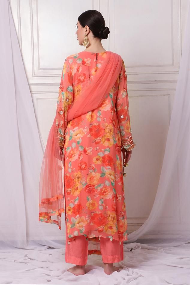 Pink georgette kurta with floral print and sequins, pearls, cutdana and stones embroidery. Comes with shantoon pant and a net dupatta.
Components: 3
Pattern: Printed, Embroidered
Type Of Work: Floral, Sequins, Pearls, Cutdana
Neckline: Leaf Neck
Sleeve Type: Full
Fabric: Kurta : Georgette, Pant : Shantoon, Dupatta : Net, Lining : Shantoon
Color: Pink
Other Details: 
Attached lining
Length :
Kurta : 50 inches
Pant : 38 inches
Product Weight : 1 Kg
Closure : Kurta - Back hook
Occasion: Sangeet - A Spring Anarkali Salwar Kameez With Mirror Work, Eid Churidar With Sheer Dupatta In Georgette, Spring Salwar Kameez With Printed Motifs In Georgette, Spring Designer Salwar Kameez With Mirror Work, Spring Traditional Wear With Mirror Work Unstitched, Spring Churidar With Sheer Dupatta, Party Dupatta With Printed Motifs For Diwali, Diwali Party Dupatta With Printed Motifs, Designer Georgette Sharara With Printed Motifs