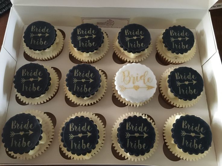 twelve cupcakes in a box decorated with bride and groom's names