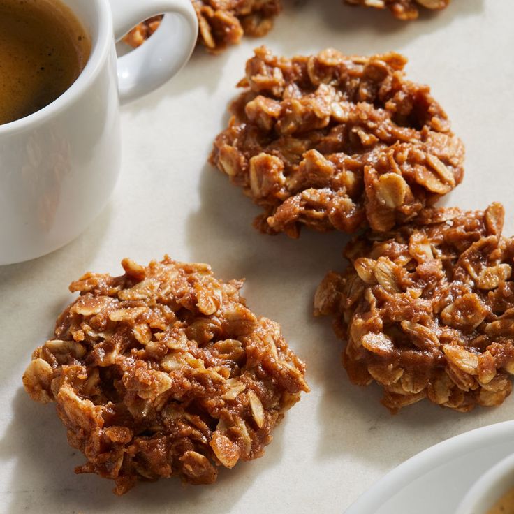 several cookies on a table next to a cup of coffee