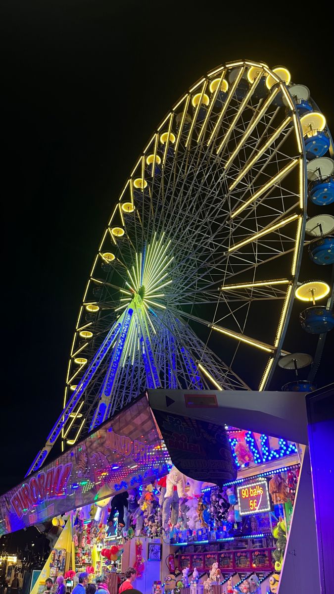 a ferris wheel is lit up at night