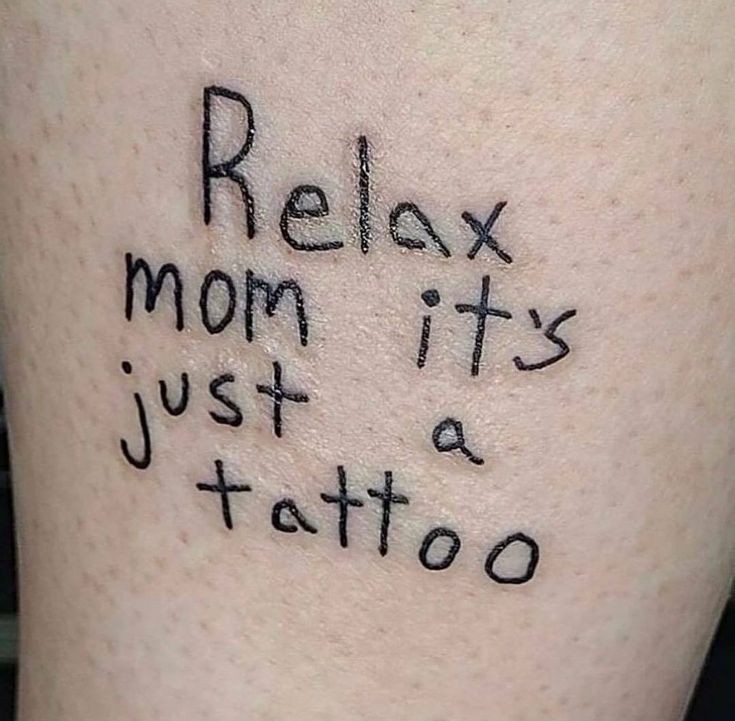 a tattoo saying relax, mom it's just a tattoo on the leg that someone has written on