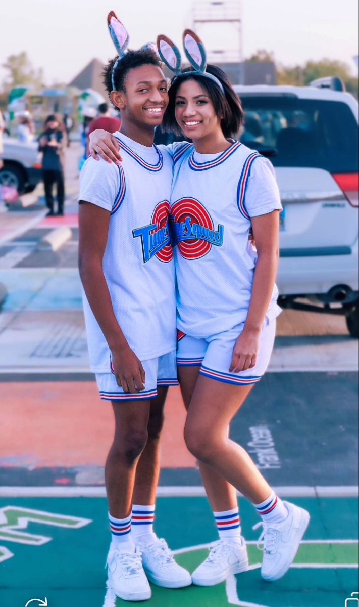 two people in bunny ears are posing for a photo on the basketball court with their arms around each other