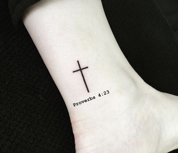 a small cross tattoo on the ankle that reads proverbb 4 13 and is written in black ink