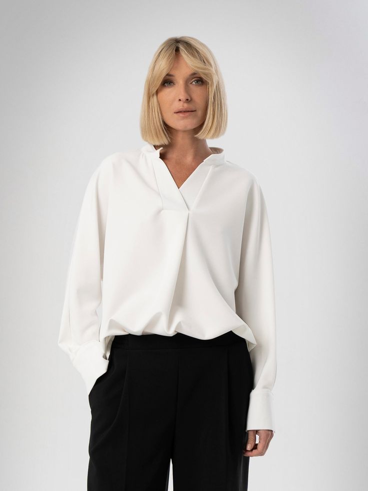 White Classy V Neck Shirt, Formal Viscose Blouse, Long Bishop Sleeves Work Top, Office Attire, Loose Oversized Blouse, White Work Classy Top. Meet our oversize white shirt made from natural viscose fabric and feature long sleeves. Whether you're looking for summer clothing or a thoughtful gift for women, minimalist design shirts are the best choice. Such a blouse will complement any style and seamlessly fits cargo pants, maxi skirt or leather jacket. Advantages:  ⁃ Suitable for all body types an Classic V-neck Relaxed Fit Blouse, Classic V-neck Blouse With Relaxed Fit, Versatile V-neck Workwear Shirt, Versatile V-neck Work Shirt, Classic Oversized V-neck Top, Versatile Oversized V-neck Blouse, Oversized Versatile V-neck Blouse, Oversized Collar Blouse For Work, Chic Long Sleeve Top For Workwear With Relaxed Fit