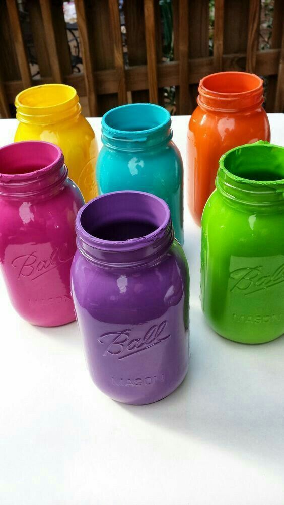 colorful mason jars lined up on a table