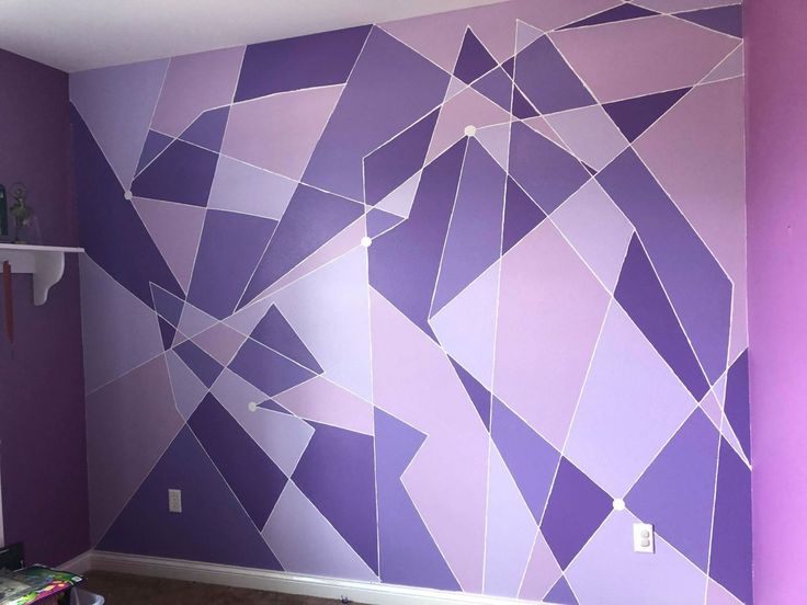 a room with purple and white wallpaper in the corner, decorated with an abstract design