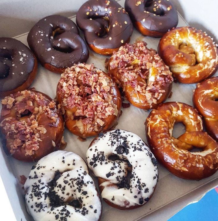 a box filled with lots of different flavored donuts