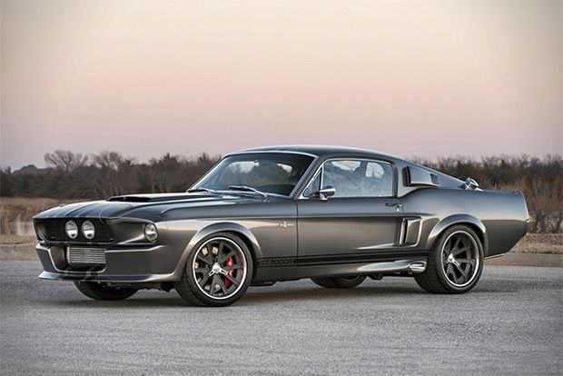 an old mustang muscle car parked in a parking lot