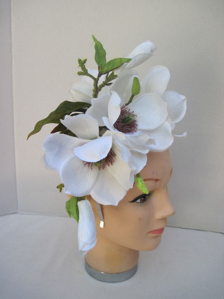 * This Magnolia headpiece has been designed on a high polish silver metal headband that is comfortable and will fit any head size. * The design has open Magnolia flowers along with buds and opening blossoms. * It can be worn all year round and for varied occasions. * All of the design is secure, evenly balance and comfortable to wear and will fit any head size. * Great to wear to Diner en Blanc, weddings, various showers, birthday celebrations, tea parties, dinner engagements, Horse Race Events, Elegant Flower Headpieces For Spring, Adjustable White Hair Accessories For Spring, Spring Headpiece With Handmade Flowers And Structured Crown, Adjustable Flower Shaped Fascinator For Garden Party, Kentucky Derby Flower Headpieces With Handmade Flowers, Spring Adjustable Headband Headpiece, Spring Adjustable Headband, Adjustable Spring Headband, Spring Headpiece With Adjustable Pinched Crown