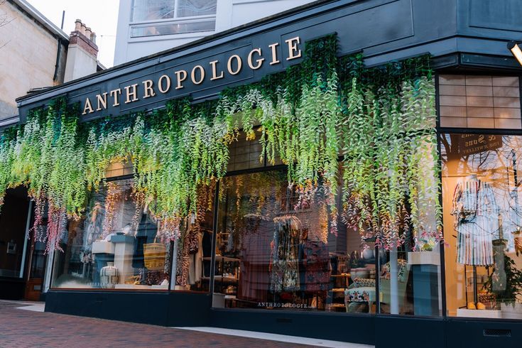 a store front with plants growing on it