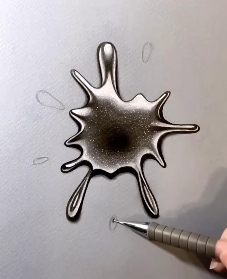 a pen drawing on the surface of a piece of paper with liquid drops coming out of it