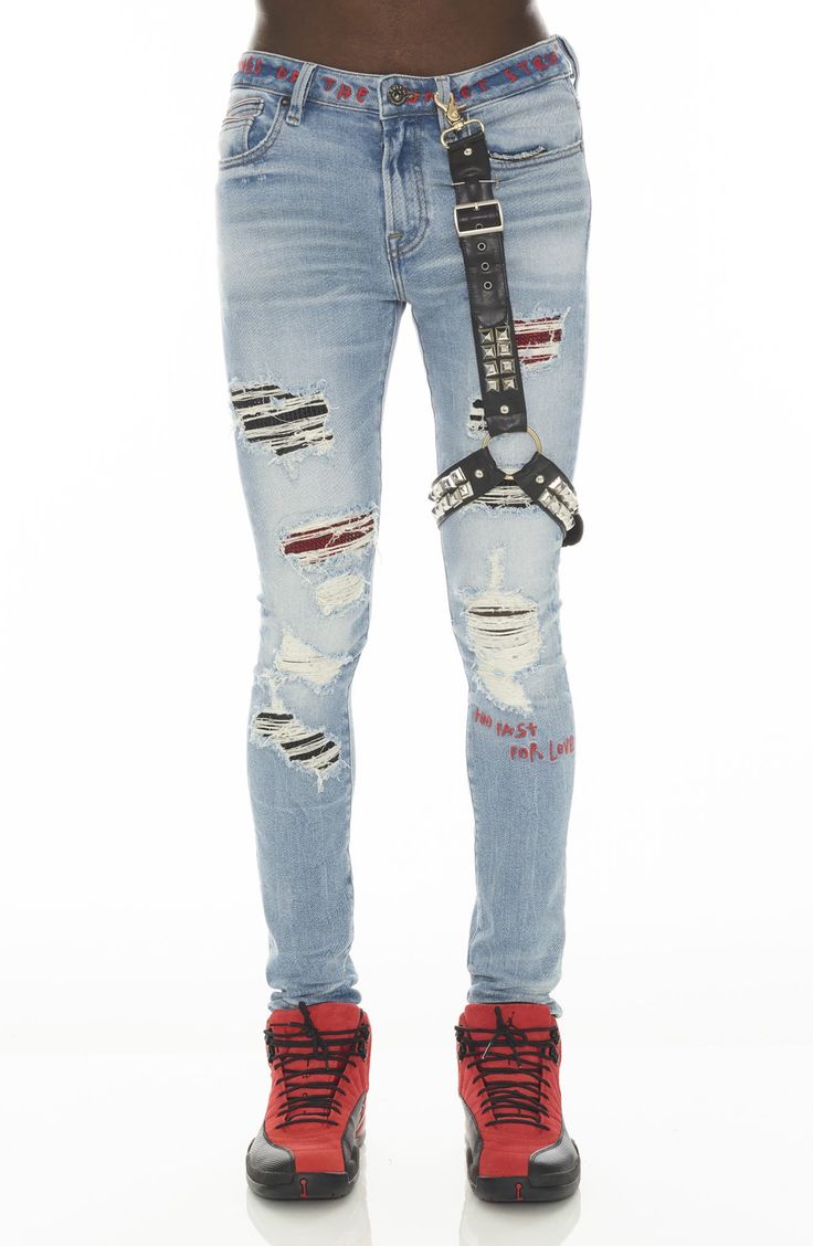 These super-skinny stretch-denim jeans are given a punk-rock update with threadbare rips and crystal backings. A studded leg harness adds to the grunge aesthetic. 32" inseam 92% cotton, 4% polyester, 4% spandex Machine wash, line dry Imported Punk Ripped Fitted Jeans, Ripped Fitted Punk Jeans, Punk Style Ripped Fitted Jeans, Fitted Ripped Punk Jeans, Alternative Style Ripped Jeans, Edgy Ripped Fitted Jeans, Fitted Punk Style Denim Jeans, Fitted Punk Jeans For Streetwear, Fitted Punk Style Jeans For Streetwear