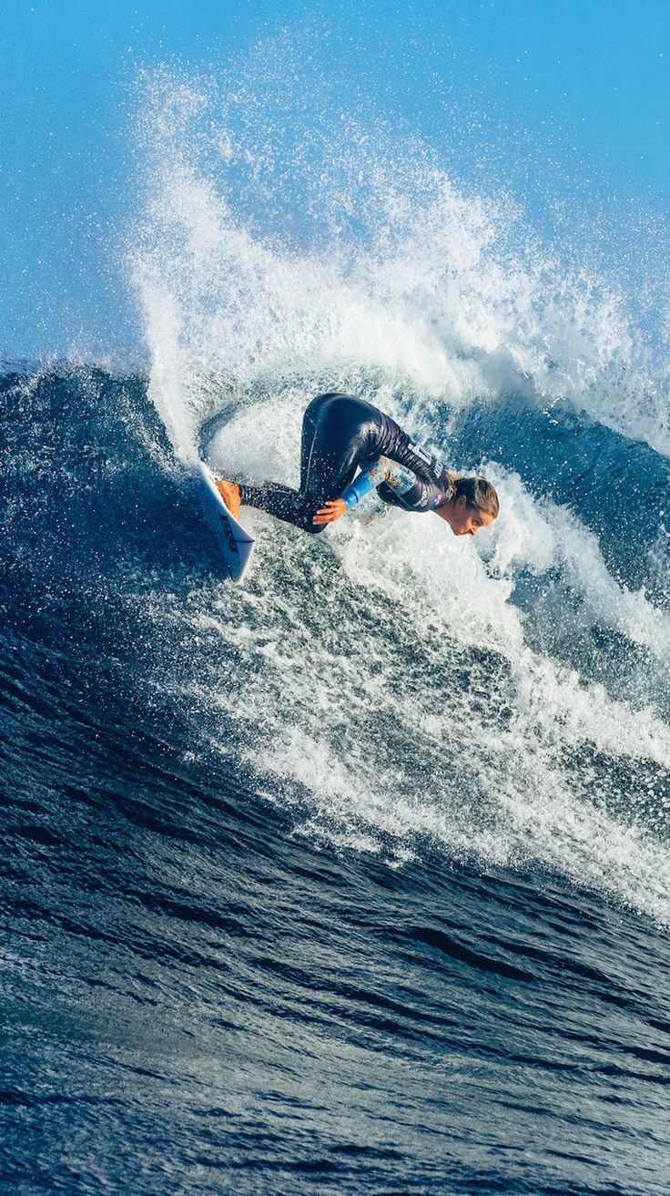 a man riding a wave on top of a surfboard