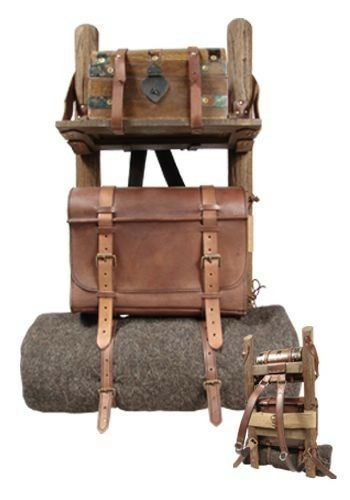 two pieces of luggage sitting next to each other on top of a pile of wood