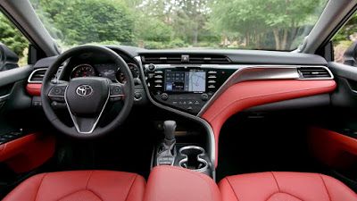 the interior of a car with red leather seats and steering wheel, dash lights, and dashboard