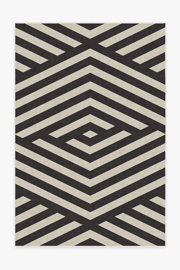 a black and white rug with an abstract design