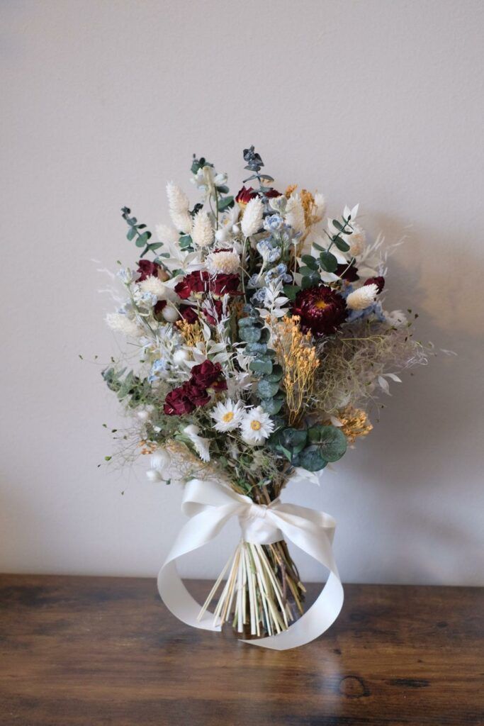 a bouquet of flowers sitting on top of a wooden table