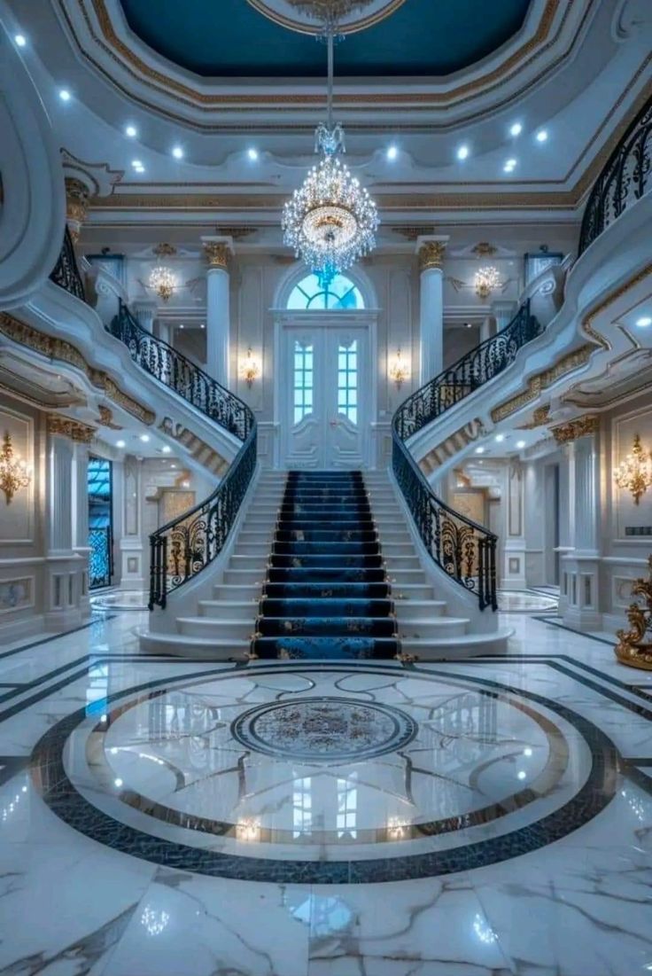 an elegant staircase with chandelier and marble floors