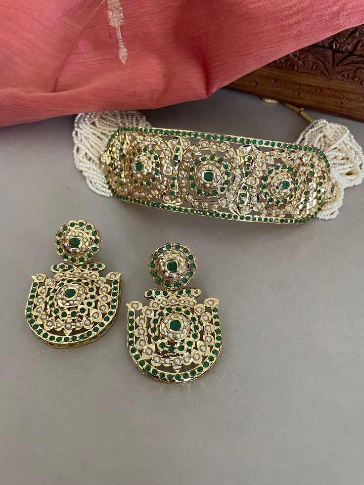 A beautiful green jadau choker set string in tiny white beads will set you apart. This high quality trendy jewelry set is a must have in your collection.  The Jadau workmanship was introduced by the Mughals and is now practiced and perfected by the skilled craftsman of Rajasthan in India.  Details: Necklace Width-1.5 Inches Earrings Length-2.25 Inches Weight of Each Earring-12 gms All products are manufactured using traditional skills from our rich heritage of crafts.  The process of these craft Traditional Pista Green Jewelry For Wedding, Adjustable Green Jewelry For Diwali, Pista Green Jewelry For Festive Wedding, Green Intricate Design Sets For Festivals, Festive Green Sets With Intricate Design, Adjustable Festive Jewelry With Zari Work, Traditional Green Hand Set Jewelry Sets, Traditional Green Hand Set Jewelry, Green Meenakari Jewelry Sets For Ceremonial Occasions