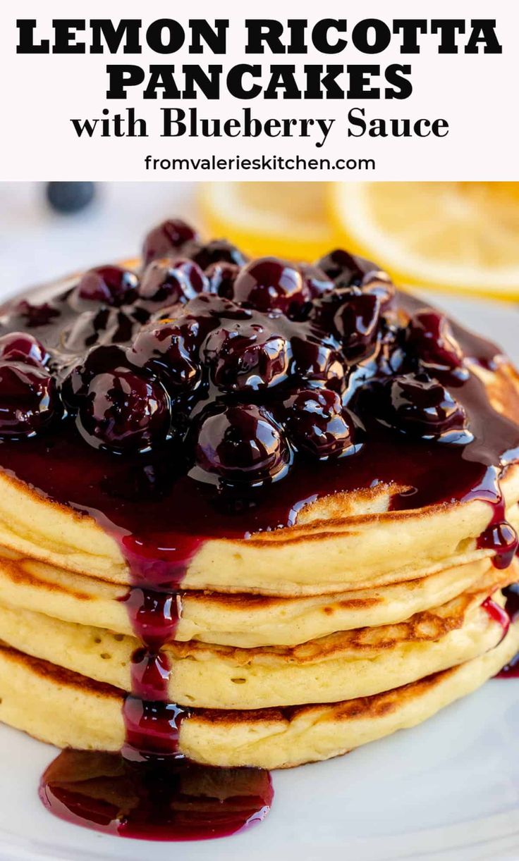 lemon ricotta pancakes with blueberry sauce on a white plate