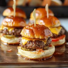 mini cheeseburgers with toothpicks on them are ready to be served in the oven