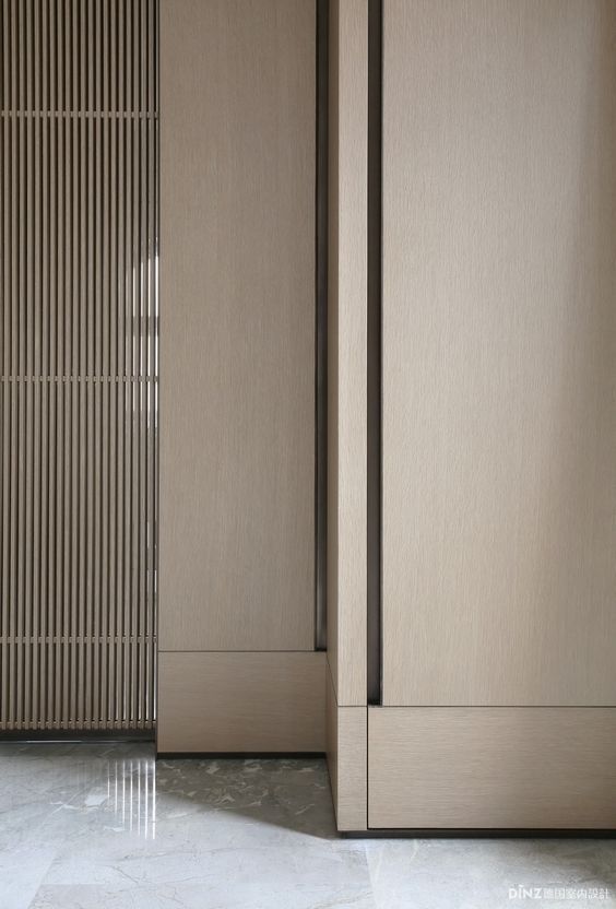 two tall wooden doors sitting next to each other in a room with tile flooring