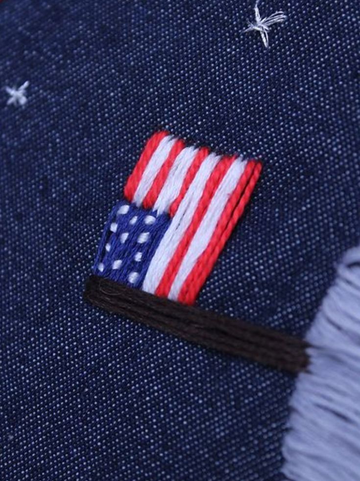 an american flag patch on the back of a blue jean jacket with stars and stripes